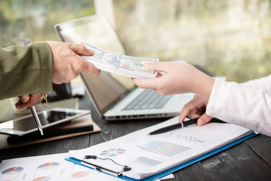 businessman giving money his partner while making contract 1